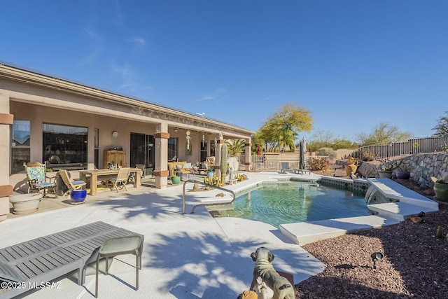 view of pool featuring pool water feature and a patio area