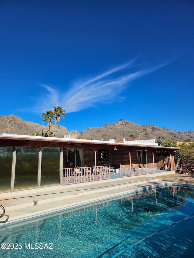 view of swimming pool featuring a mountain view