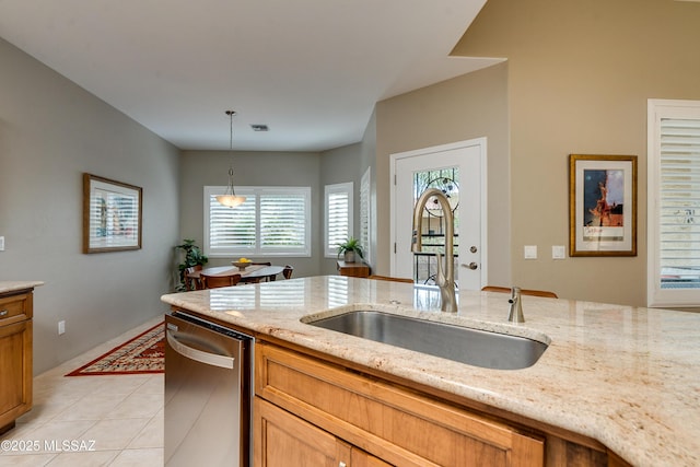 kitchen with visible vents, light stone countertops, pendant lighting, dishwasher, and a sink