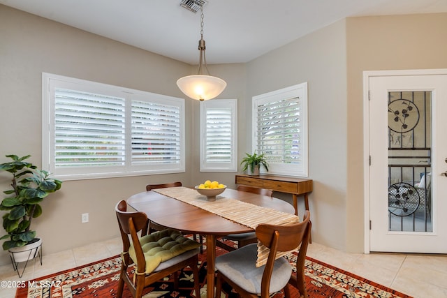 dining space featuring light tile patterned flooring and visible vents