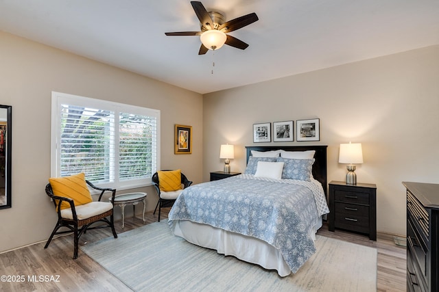 bedroom with a ceiling fan and light wood finished floors