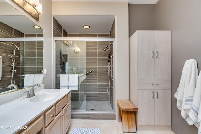 full bath with a stall shower, vanity, and tile patterned flooring