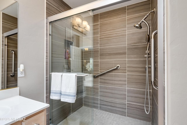 bathroom featuring a stall shower and vanity