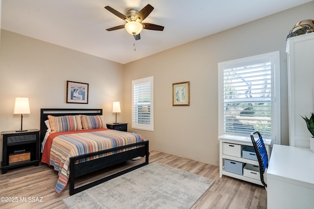 bedroom with ceiling fan and light wood-style floors