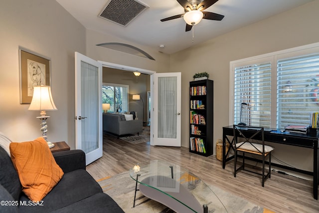 office area featuring visible vents, french doors, ceiling fan, and wood finished floors