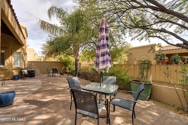 view of patio / terrace featuring outdoor dining area and a fenced backyard