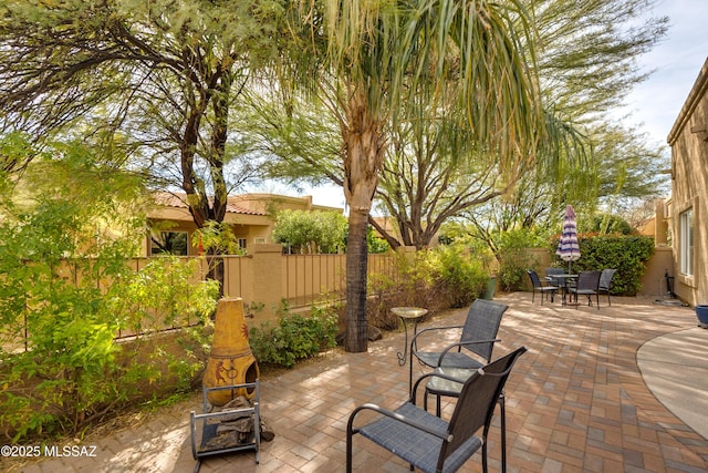 view of patio with outdoor dining area and fence private yard