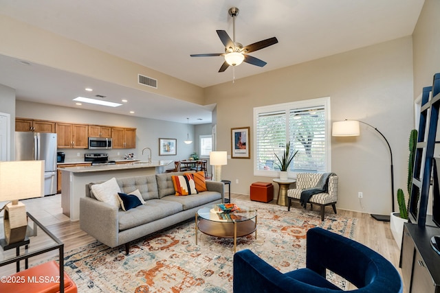 living area featuring recessed lighting, visible vents, light wood finished floors, and ceiling fan