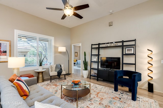 living room with a ceiling fan and wood finished floors