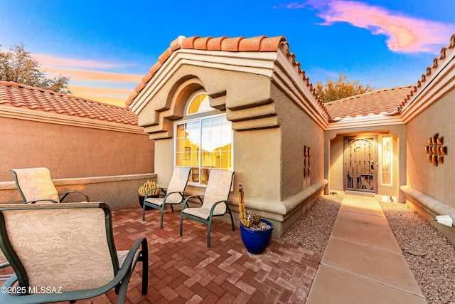 view of patio terrace at dusk