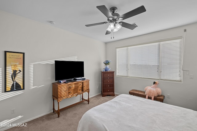 bedroom featuring light carpet and ceiling fan