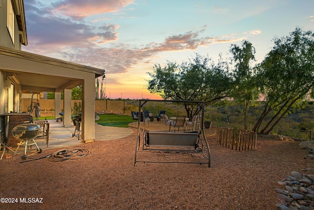 yard at dusk with a patio area