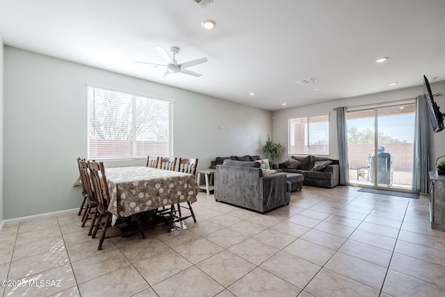 tiled dining space with ceiling fan