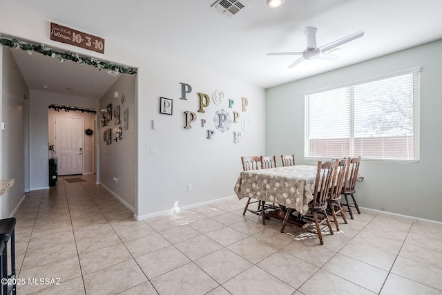 tiled dining room with ceiling fan