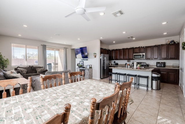 dining room featuring light tile patterned flooring and ceiling fan