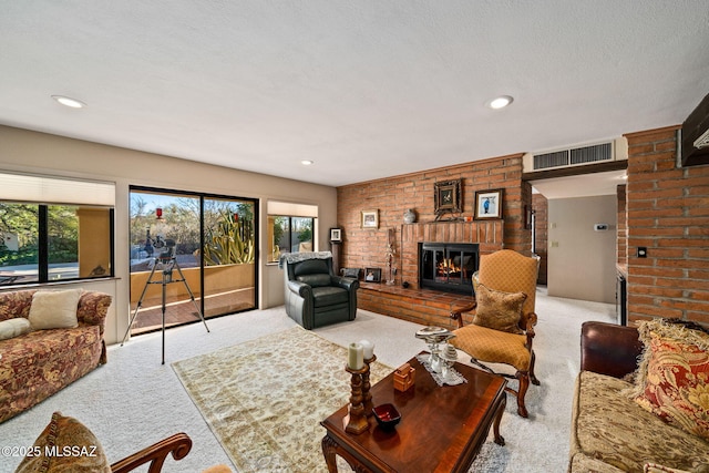 carpeted living room with a fireplace, a textured ceiling, and a wealth of natural light