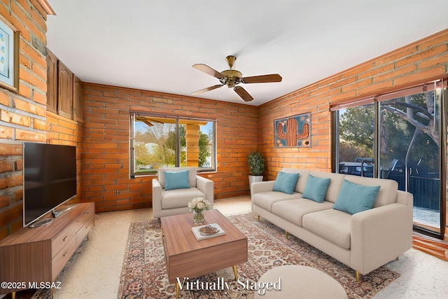 living room featuring ceiling fan, brick wall, and a wealth of natural light