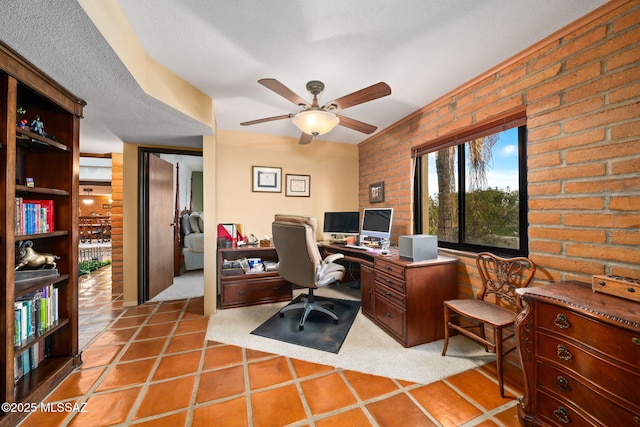 office space featuring ceiling fan, brick wall, a textured ceiling, and light tile patterned floors