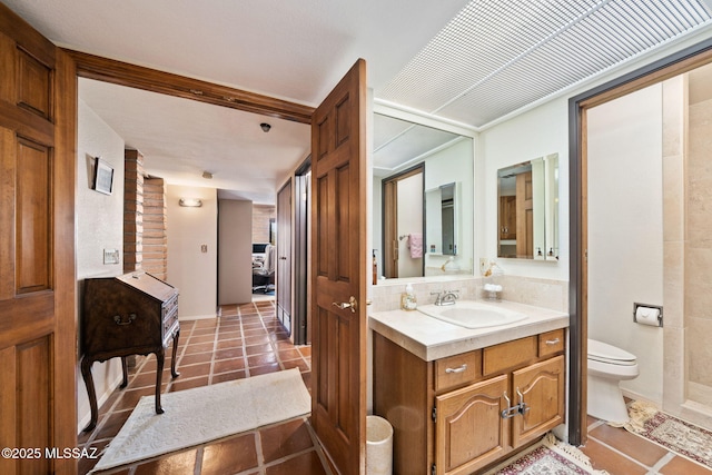 bathroom featuring tile patterned floors, vanity, and toilet