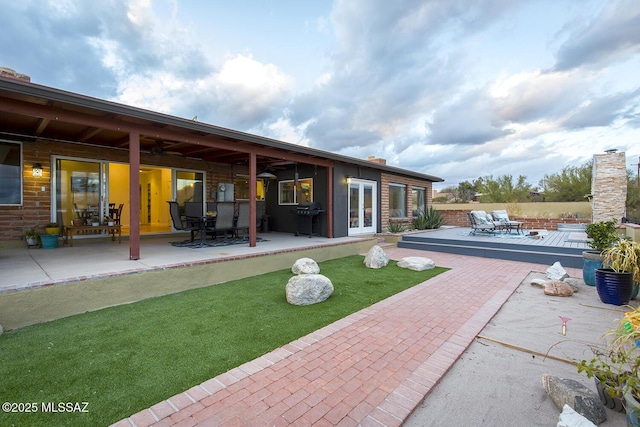 rear view of house featuring french doors, a patio area, ceiling fan, and fence