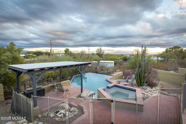 view of swimming pool with a patio area and a pool with connected hot tub