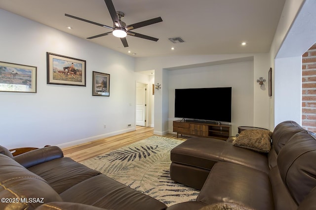 living room featuring light wood-type flooring, visible vents, a ceiling fan, recessed lighting, and baseboards