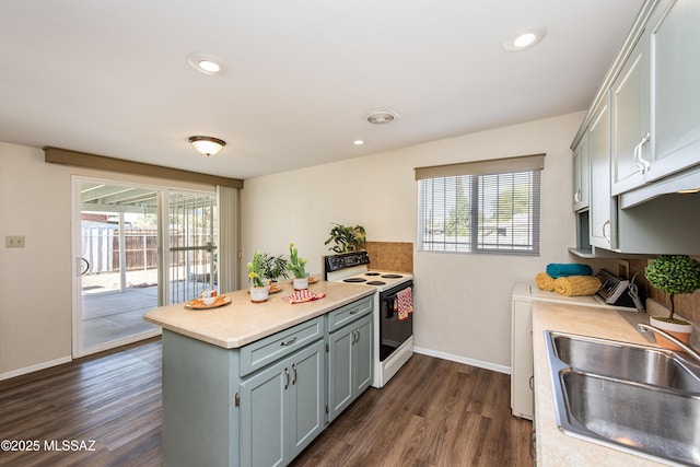 kitchen with sink, white electric range, a wealth of natural light, and dark hardwood / wood-style floors