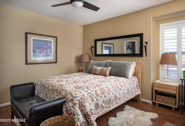 bedroom with multiple windows, dark wood-type flooring, and ceiling fan