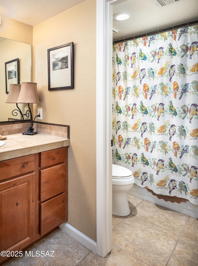 bathroom with a shower with curtain, tile patterned floors, vanity, and toilet