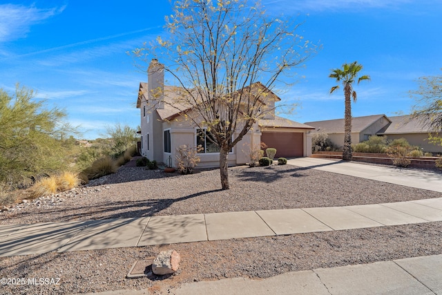 view of front of property with a garage, driveway, and stucco siding