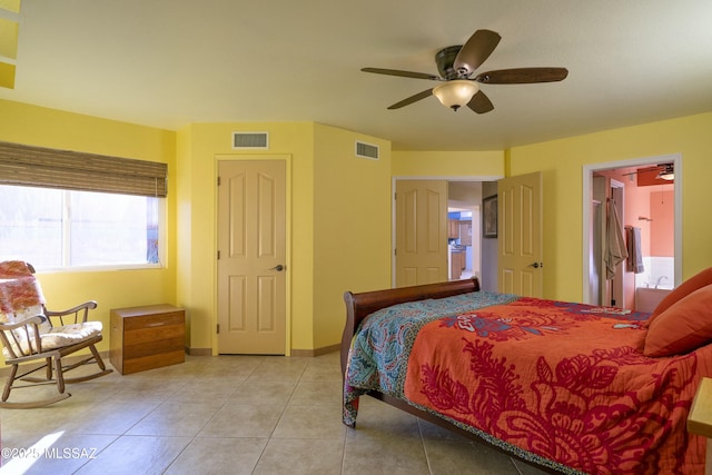 bedroom with a ceiling fan, light tile patterned flooring, visible vents, and baseboards