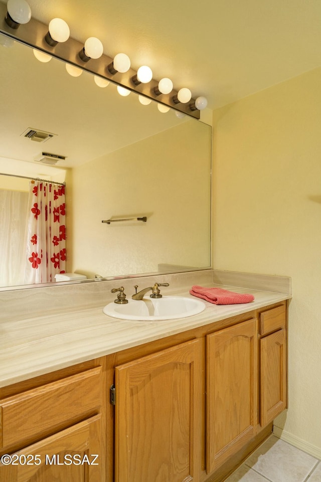 bathroom with tile patterned flooring, visible vents, and vanity