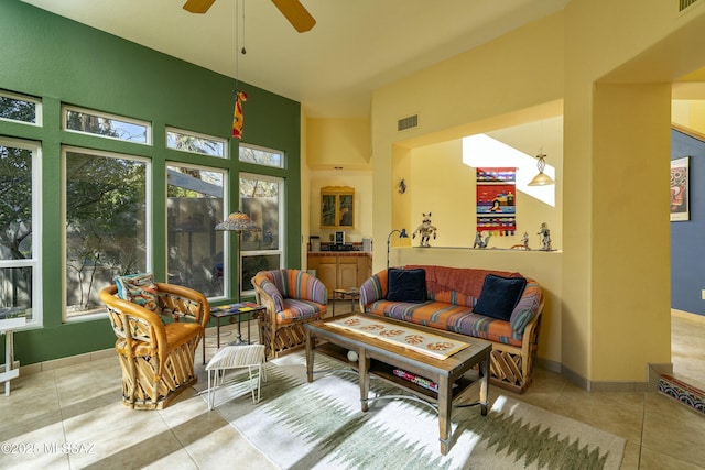 sunroom / solarium featuring visible vents and a ceiling fan