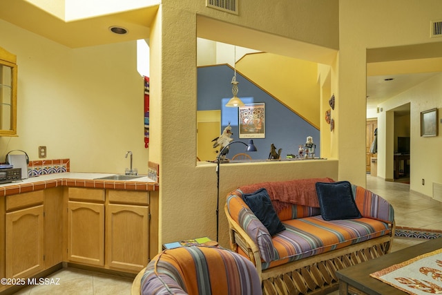 living room featuring light tile patterned floors and visible vents