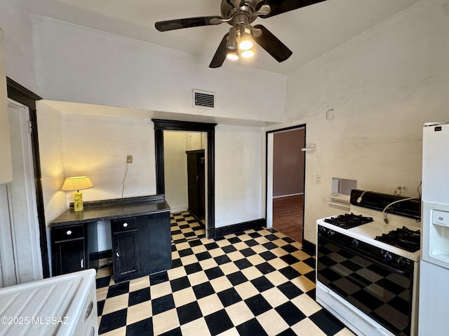 kitchen with visible vents, ceiling fan, light floors, white fridge with ice dispenser, and gas stove