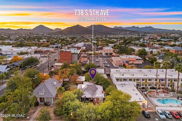 aerial view at dusk featuring a residential view and a mountain view