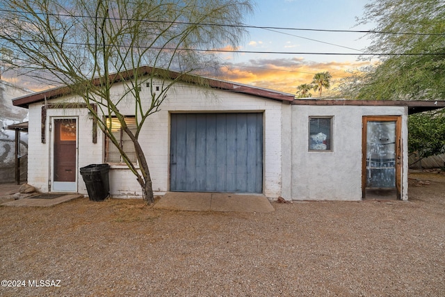 view of garage at dusk