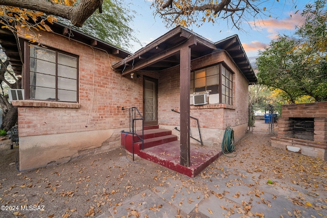 view of front of property with a gate and brick siding