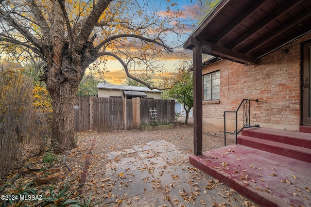 view of yard with fence and a patio