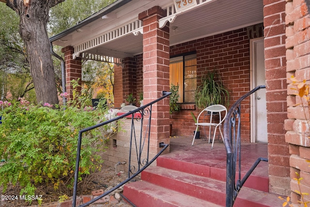 view of exterior entry featuring brick siding