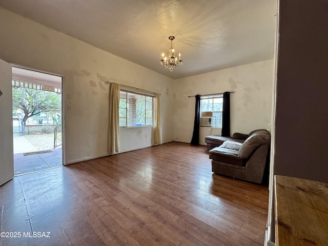 living room featuring wood finished floors and a notable chandelier