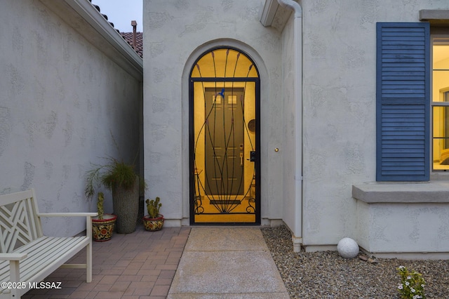 property entrance with stucco siding