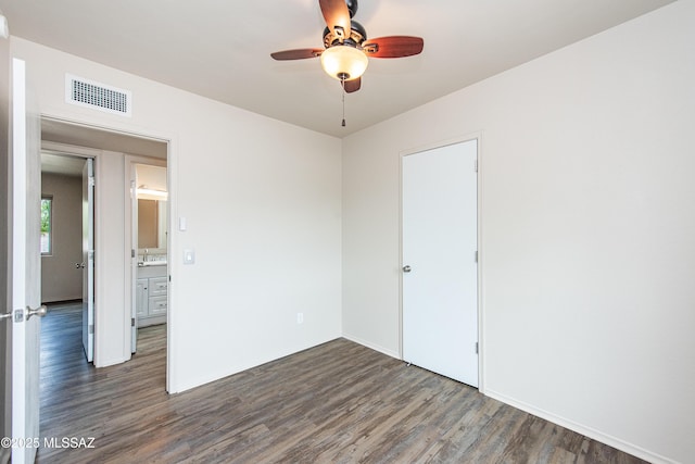 unfurnished bedroom with dark wood finished floors, baseboards, visible vents, and ceiling fan