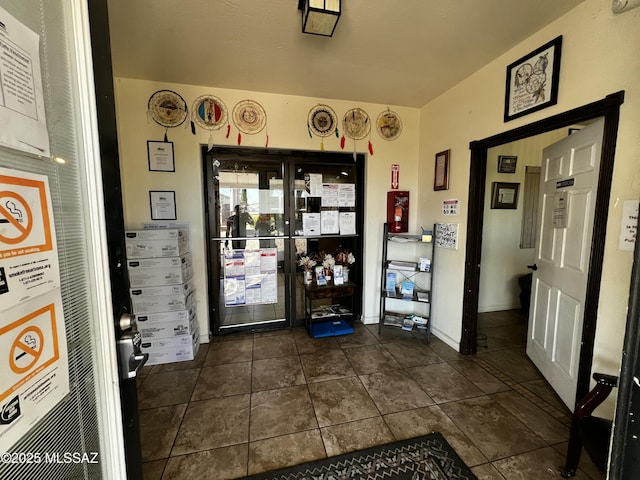 foyer entrance with dark tile patterned floors