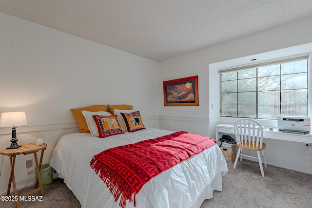 bedroom with carpet floors and a textured ceiling