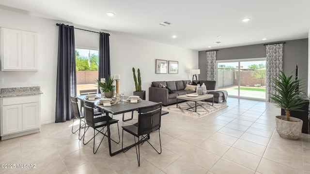 tiled dining space featuring a wealth of natural light