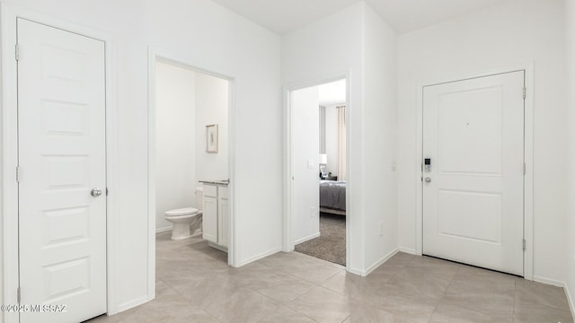 corridor featuring light tile patterned flooring