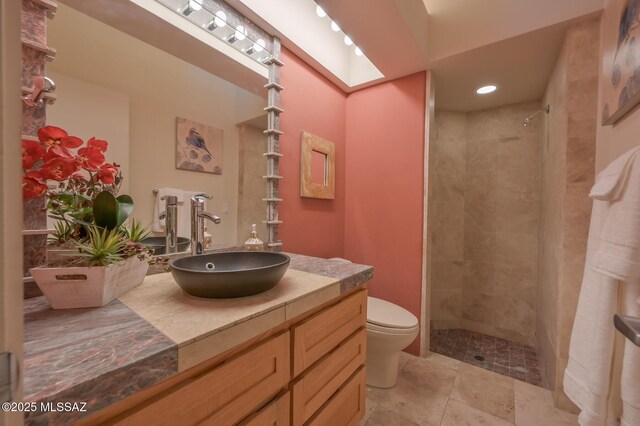 bathroom with vanity, tiled tub, and tile patterned flooring