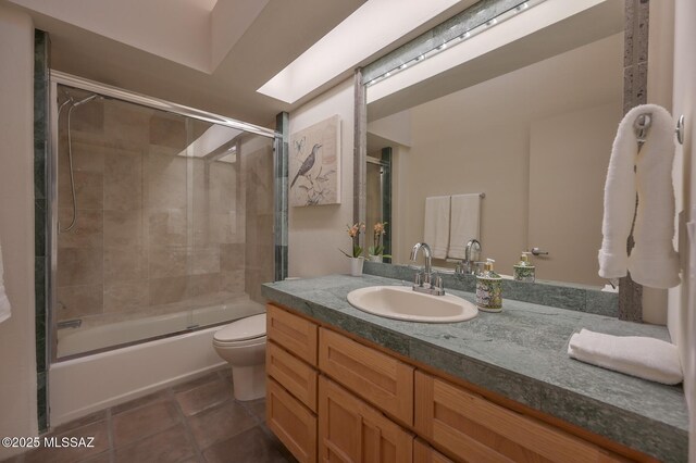 bathroom with vanity, a skylight, and tile patterned floors