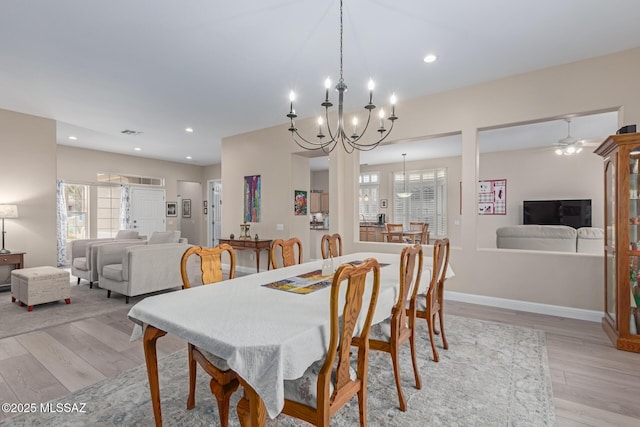 dining area with light wood-type flooring, baseboards, and recessed lighting